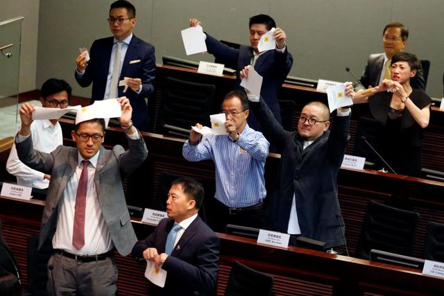 Pro-democracy lawmakers tear apart ballots as they boycott the process of electing council chairman at the Legislative Council in Hong Kong. (REUTERS) Pro-democracy lawmakers tear apart ballots as they boycott the process of electing council chairman at the Legislative Council in Hong Kong. (REUTERS)