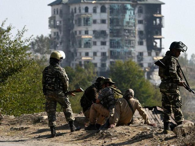 Security forces keep guard outside the EDI building at Pampore where militants are holed up . The standoff entered its third day on Wednesday. (PTI) Security forces keep guard outside the EDI building at Pampore where militants are holed up . The standoff entered its third day on Wednesday. (PTI)