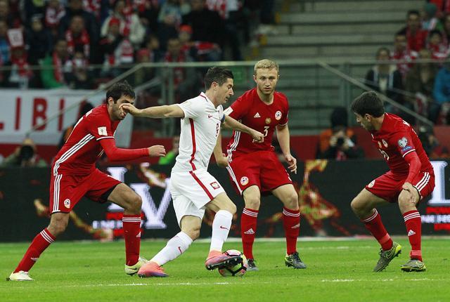 Poland's Robert Lewandowski challenges Armenia's Gael Andonian, Varazdat Haroyan and Levon Hayrapetyanm during their World Cup Group E qualifying football match in Warsaw. (AP Photo) Poland's Robert Lewandowski challenges Armenia's Gael Andonian, Varazdat Haroyan and Levon Hayrapetyanm during their World Cup Group E qualifying football match in Warsaw. (AP Photo)
