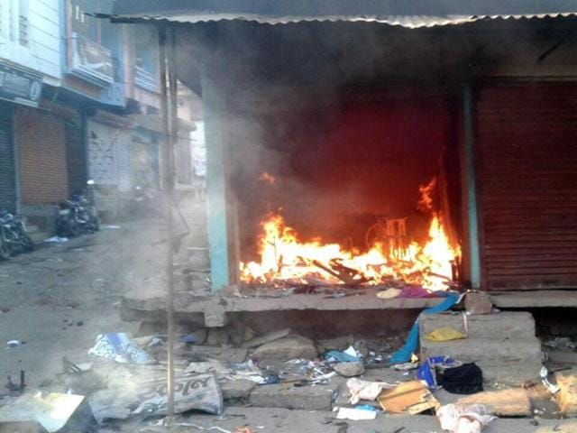 A shop burns during a communal violence in Gandhwani, Dhar district on Wednesday.(HT photo)