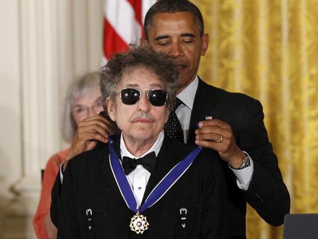 US President Barack Obama presents rock legend Bob Dylan with a Medal of Freedom during a ceremony at the White House in Washington. (AP Photo)