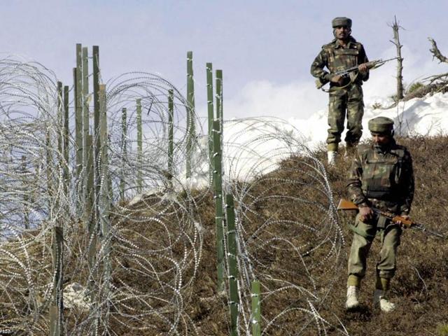 This file photograph taken on December 4, 2003, shows Indian soldiers as they patrol along a barbed-wire fence near Baras Post on the Line of Control (LoC) between Pakistan and India some 174km north west of Srinagar.(AFP)
