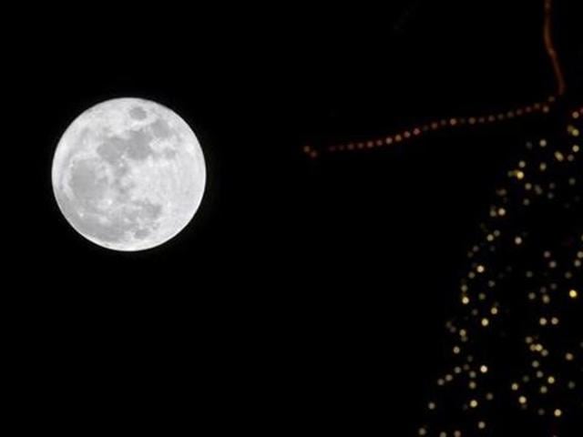 A full moon rises in the sky over a Christmas tree in Beirut, Lebanon. (Reuters File Photo) A full moon rises in the sky over a Christmas tree in Beirut, Lebanon. (Reuters File Photo)