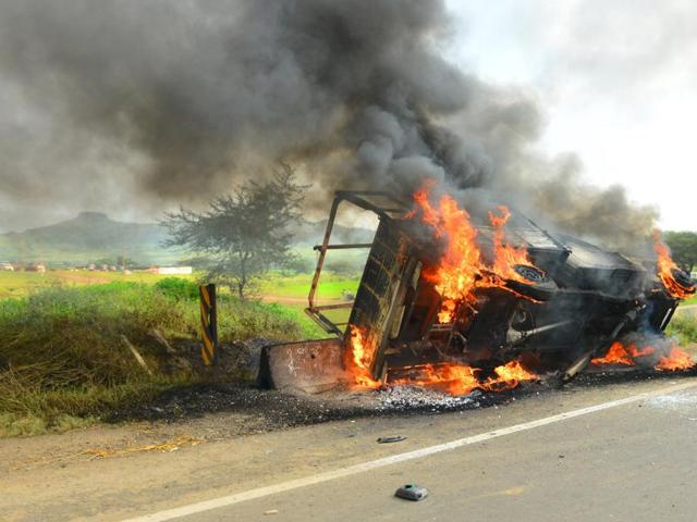 After the incident, locals from Talegaon near Tribakeshwar torched government buses and pelted stones at the convoy of water resources minister Girish Mahajan. (HT PHOTO)