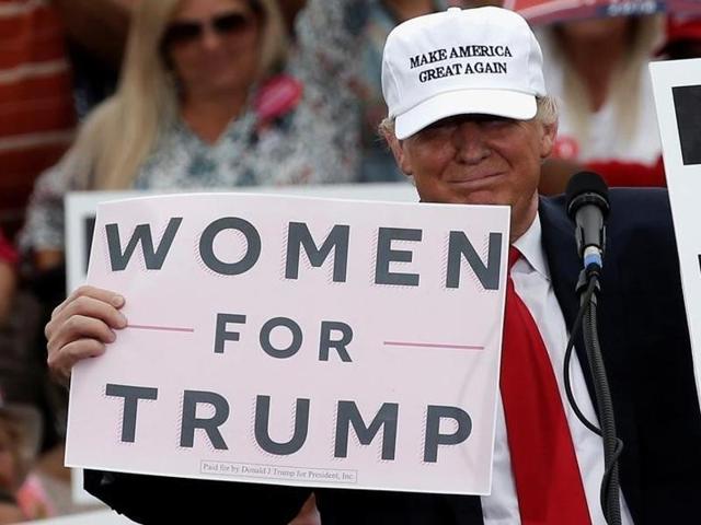 Republican US presidential nominee Donald Trump holds up signs at the end of a campaign rally in Lakeland, Florida. (Reuters) Republican US presidential nominee Donald Trump holds up signs at the end of a campaign rally in Lakeland, Florida. (Reuters)