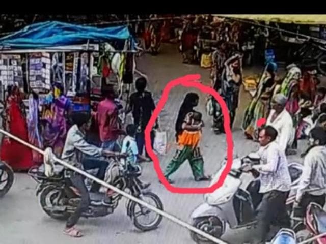 The CCTV grab shows a woman carrying a baby that wore a dress similar to Benu, who went missing from the Sanawa marketplace.(HT)