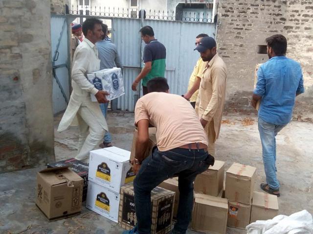 Excise and taxation department staff with illicit liqour seized from a political worker’s house at Rampura village in Bathinda district. (HT File Photo) Excise and taxation department staff with illicit liqour seized from a political worker’s house at Rampura village in Bathinda district. (HT File Photo)