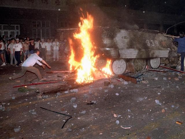 A student protester puts barricades in the path of a burning armoured personnel carrier that rammed through student lines during an army attack on anti-government demonstrators in Beijing's Tiananmen Square on June 4, 1989. (AP File Photo) A student protester puts barricades in the path of a burning armoured personnel carrier that rammed through student lines during an army attack on anti-government demonstrators in Beijing's Tiananmen Square on June 4, 1989. (AP File Photo)