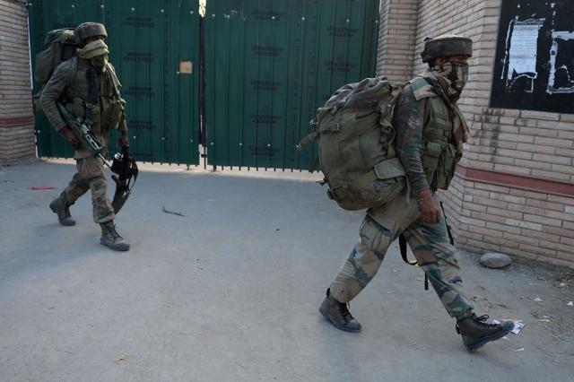 Indian army commandoes walk from a building after two suspected militants were killed in a gunbattle in Pampore, south of Srinagar, on Thursday. (AFP)