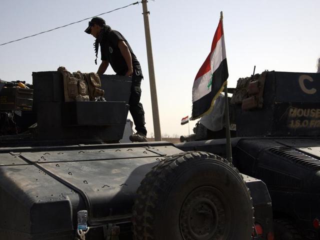 An Iraqi special forces soldier deployed for an offensive to retake Mosul from Islamic State militants prepares to move out from a camp near Khazer, Iraq, on Friday. (AP) An Iraqi special forces soldier deployed for an offensive to retake Mosul from Islamic State militants prepares to move out from a camp near Khazer, Iraq, on Friday. (AP)