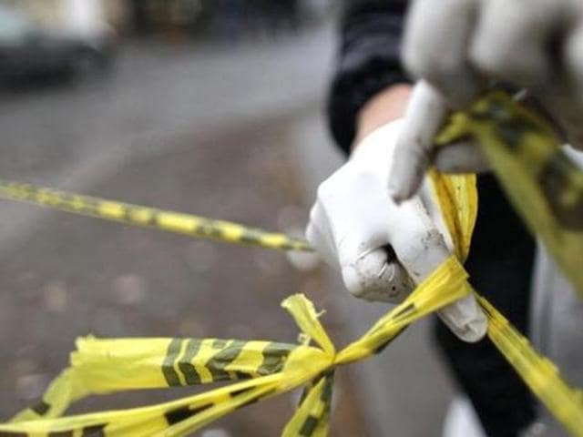 A forensic technician ties a used police line together to seal off a crime scene. (Representational Image: Shutterstock) A forensic technician ties a used police line together to seal off a crime scene. (Representational Image: Shutterstock)