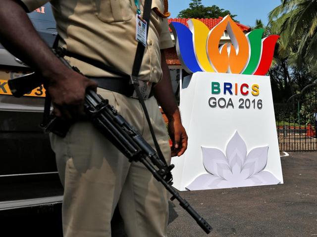 A man rides past a billboard near one of the venues of BRICS Summit in Goa.(REUTERS)