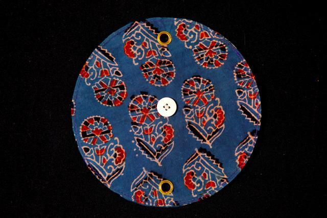 The sculptural button with ajrakh prints. Ajrakh is a laborious process involving 20 stages.