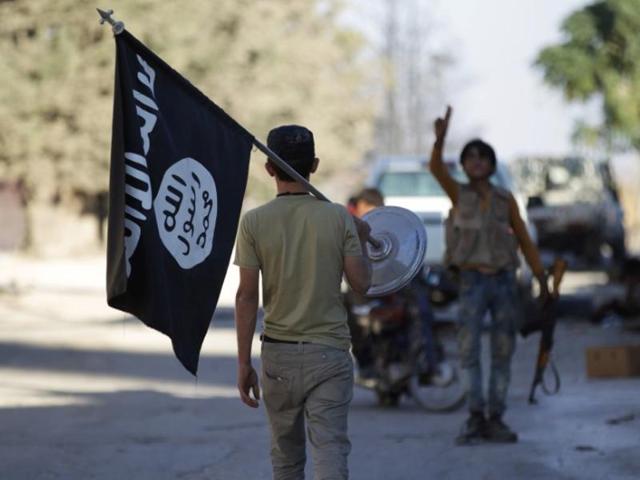 A rebel fighter takes away a flag that belonged to the Islamic State in Akhtarin village in northern Aleppo. (Reuters) A rebel fighter takes away a flag that belonged to the Islamic State in Akhtarin village in northern Aleppo. (Reuters)