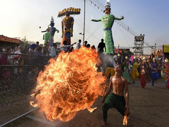 A fire stunt artiste performs during the effigy-buring of Ravana, on Dussehra at the Lovkush Ramlila at Red fort in New Delhi on October 11, 2016. Dussehra commemorates the triumph of Lord Rama over the Ravana, marking the victory of good over evil. (Sonu Mehta/HT PHOTO) A fire stunt artiste performs during the effigy-buring of Ravana, on Dussehra at the Lovkush Ramlila at Red fort in New Delhi on October 11, 2016. Dussehra commemorates the triumph of Lord Rama over the Ravana, marking the victory of good over evil. (Sonu Mehta/HT PHOTO)