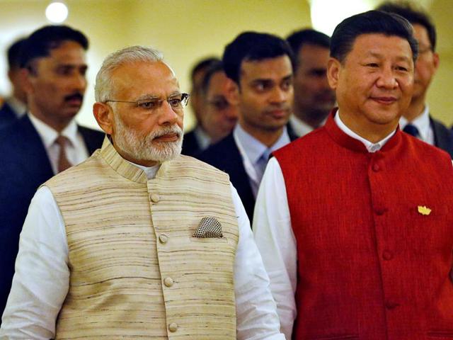 Prime Minister Narendra Modi and Chinese President Xi Jinping arrive for a photo opportunity ahead of BRICS Summit in Benaulim, Goa, on Saturday.(REUTERS)