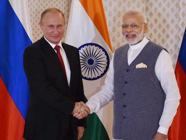 Russian President Vladimir Putin being welcomed by Prime Minister Narendra Modi ahead of 17th India-Russia annual summit meet in Benaulim, Goa on Saturday.(PTI Photo)