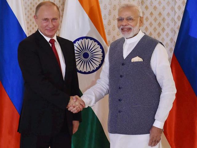 Russian President Vladimir Putin was welcomed by Prime Minister Narendra Modi ahead of the 17th India-Russia annual summit meet in Benaulim, Goa.(PTI Photo)