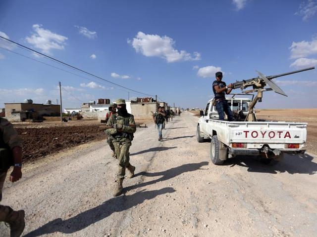 Rebel fighters walk as they advance towards Azaz city, Aleppo, Syria. (REUTERS) Rebel fighters walk as they advance towards Azaz city, Aleppo, Syria. (REUTERS)