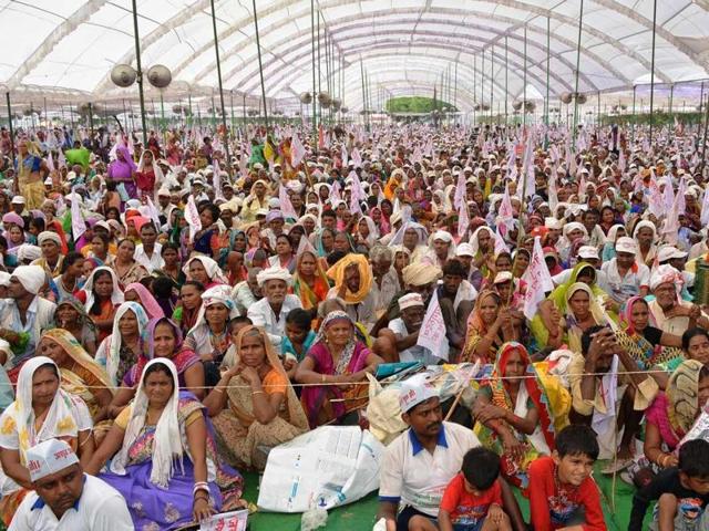 A gathering of Jai Gurudev followers at Domri village on Sunday, a day after a stampede broke out during a religious gathering in which 25 people lost their lives.(HT Photo) A gathering of Jai Gurudev followers at Domri village on Sunday, a day after a stampede broke out during a religious gathering in which 25 people lost their lives.(HT Photo)