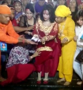 Controversial godwoman Radhe Maa offers prayers with shoes on at Har-ki-Pauri in Haridwar. (HT Photo)