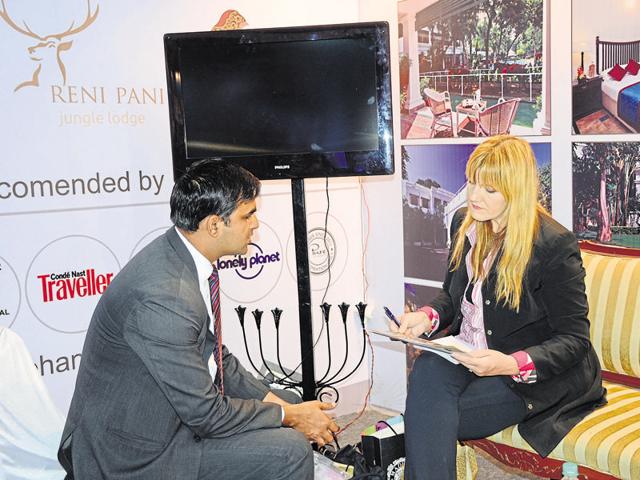 A foreign delegate at a kiosk set up for the third MP Travel Mart at a Bhopal hotel on Saturday.(Chandresh Mathur/HT)