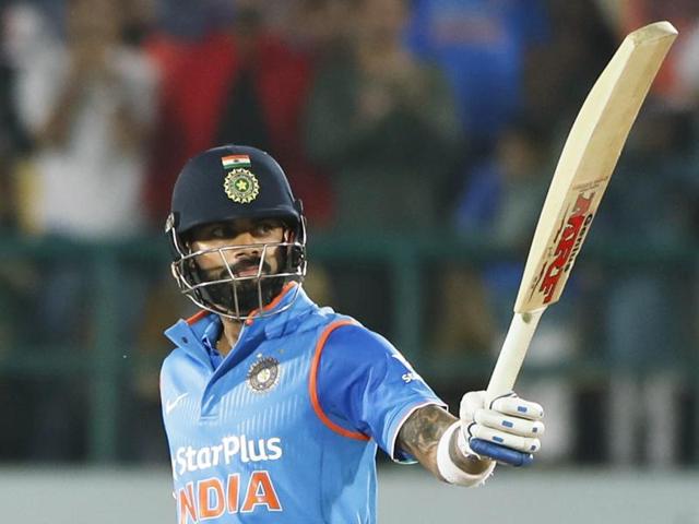 India's Virat Kohli raises his bats after scoring a half century. (AP Photo)