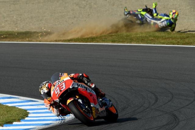 Marquez (front) takes a corner as Rossi (top) crashes. (AFP) Marquez (front) takes a corner as Rossi (top) crashes. (AFP)