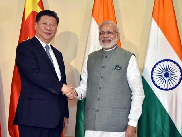 Prime Minister Narendra Modi shakes hands with Chinese President Xi Jinping ahead of the BRICS Summit, in Goa.(PTI Photo)