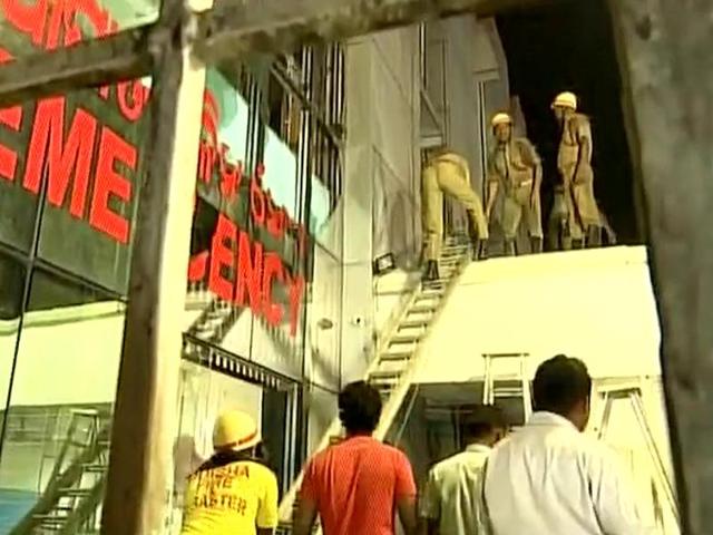 Fire fighters use a ladder to get into the fire-affected area of SUM Hospital in Bhubaneshwar on Monday.(ANI)