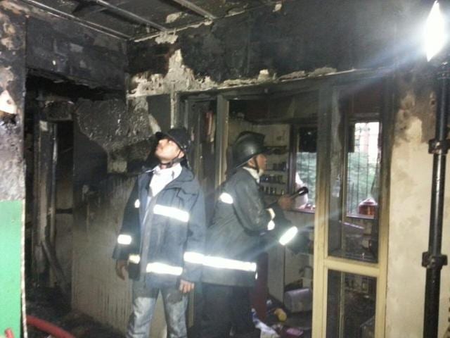 Fire Brigade personnel at the spot where the fire broke out. (HT Photo) Fire Brigade personnel at the spot where the fire broke out. (HT Photo)