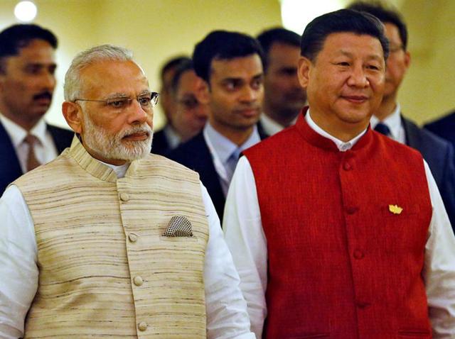 Prime Minister Narendra Modi and Chinese President Xi Jinping arrive for a photo opportunity ahead of the BRICS Summit in Benaulim, Goa.(Reuters)