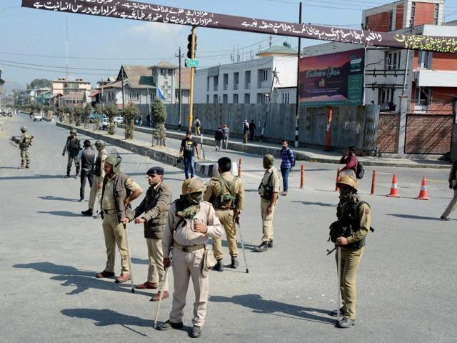 Security personnel stand guard at a blocked road in Srinagar. (PTI) Security personnel stand guard at a blocked road in Srinagar. (PTI)
