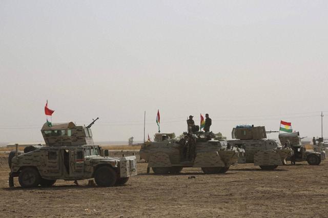 A peshmerga convoy drives towards a frontline in Khazer, about 30 kilometers (19 miles) east of Mosul. (AP) A peshmerga convoy drives towards a frontline in Khazer, about 30 kilometers (19 miles) east of Mosul. (AP)