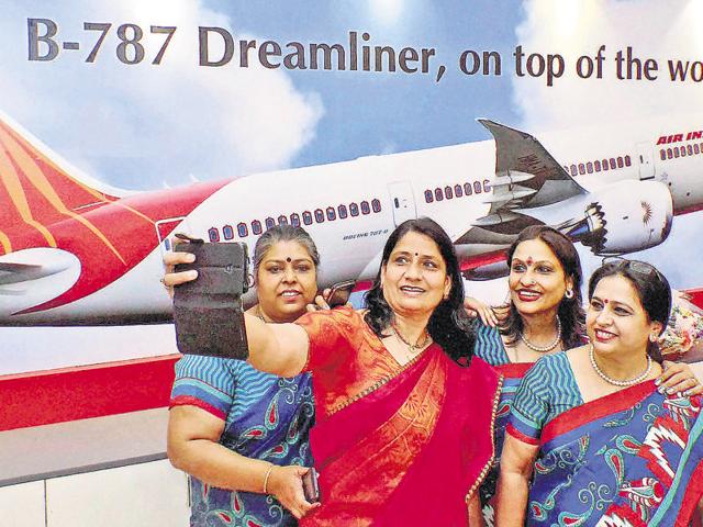 Bengaluru : Air India employees with a passenger takes a selfie during the inauguration of the new Air India City Booking office at Unity Building in Bengaluru on Monday. PTI Photo / Free (PTI10_3_2016_000216B)(PTI) Bengaluru : Air India employees with a passenger takes a selfie during the inauguration of the new Air India City Booking office at Unity Building in Bengaluru on Monday. PTI Photo / Free (PTI10_3_2016_000216B)(PTI)