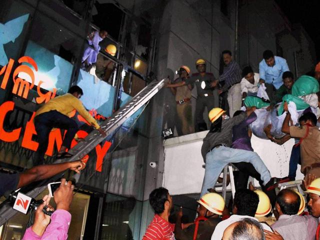 Patients being shifted from SUM Hospital where a fire broke in Bhubaneswar. (PTI Photo) Patients being shifted from SUM Hospital where a fire broke in Bhubaneswar. (PTI Photo)