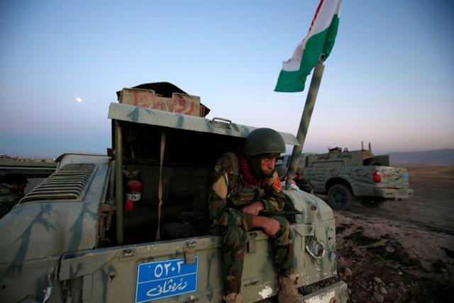 A member of Peshmerga forces sits in the back of the military vehicle in the east of Mosul during operation to attack Islamic State militants in Mosul on Monday. (REUTERS) A member of Peshmerga forces sits in the back of the military vehicle in the east of Mosul during operation to attack Islamic State militants in Mosul on Monday. (REUTERS)
