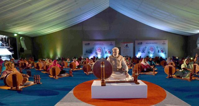 Modi works on a charkha at a ceremony to distribute charkhas to women in Ludhiana on Tuesday.. (PTI Photo) Modi works on a charkha at a ceremony to distribute charkhas to women in Ludhiana on Tuesday.. (PTI Photo)