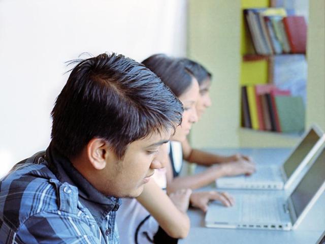 Group of Indian / Asian college students studying in the library using laptop computers. (Getty Images/iStockphoto) Group of Indian / Asian college students studying in the library using laptop computers. (Getty Images/iStockphoto)