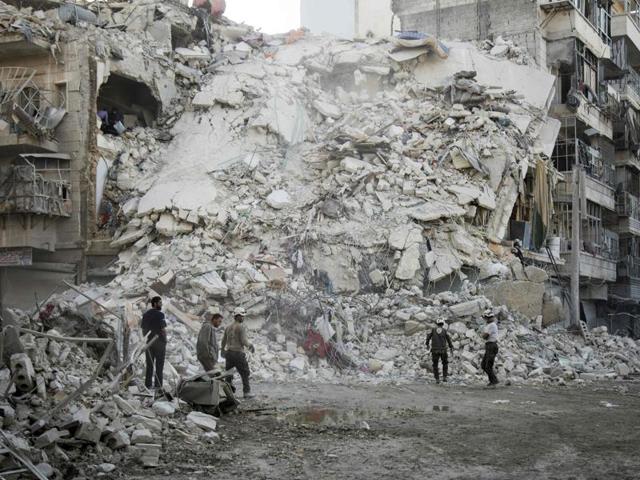 Members of the Syrian Civil Defence, known as the White Helmets, search for victims amid the rubble of a destroyed building following reported air strikes in the rebel-held Qatarji neighbourhood in Aleppo. (AFP) Members of the Syrian Civil Defence, known as the White Helmets, search for victims amid the rubble of a destroyed building following reported air strikes in the rebel-held Qatarji neighbourhood in Aleppo. (AFP)