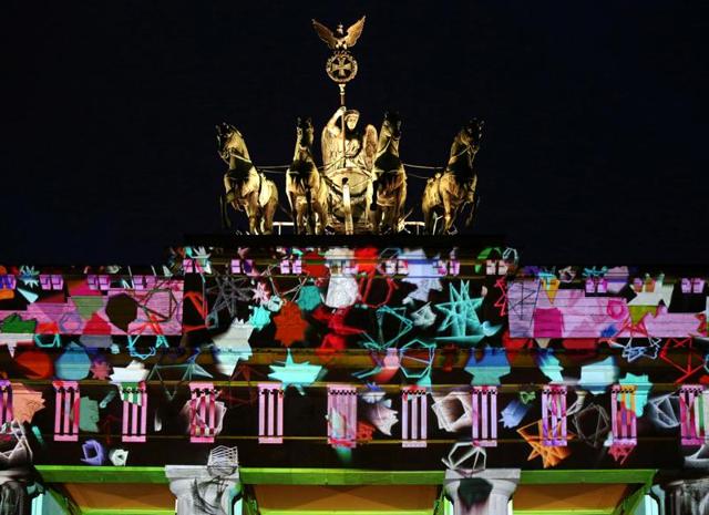 The Quadriga on top of the Brandenburg Gate is illuminated during the Festival of Lights show in Berlin, Germany. (REUTERS)