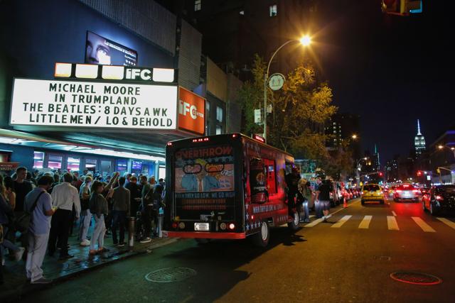 People wait in line outside the IFC Theater before the debut of a surprise documentary about Republican nominee Donald Trump titled TrumpLand by US filmmaker Michael Moore in New York. (AFP)