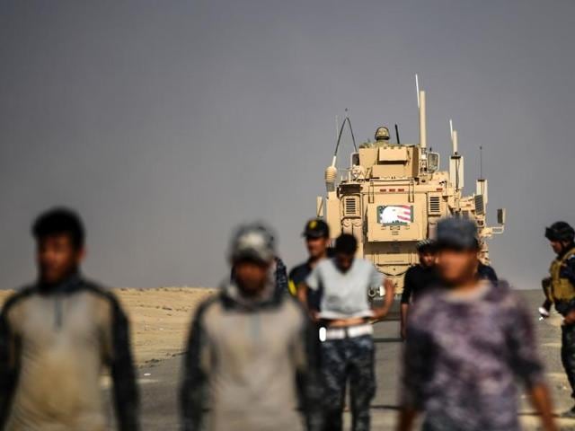 Members of the Iraqi forces walk near an armoured vehicle used by US forces supporting Iraq troops during the operation to recapture Mosul from the Islamic State group, at the Qayyarah military base. (AFP) Members of the Iraqi forces walk near an armoured vehicle used by US forces supporting Iraq troops during the operation to recapture Mosul from the Islamic State group, at the Qayyarah military base. (AFP)