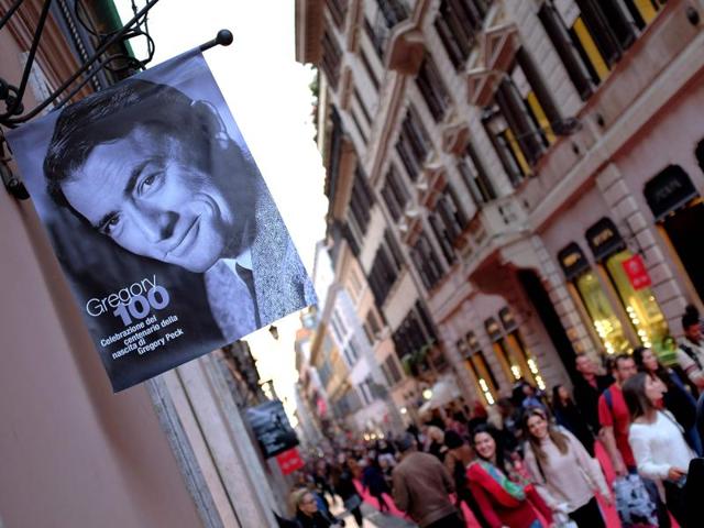 People walk by a portrait of late US actor Gregory Peck through Via Condotti, partly covered by a red carpet, on October 18, 2016 in Rome during a series of events during the 11th Rome Film Festival marking the centenary of the birth of Gregory Peck. (AFP) People walk by a portrait of late US actor Gregory Peck through Via Condotti, partly covered by a red carpet, on October 18, 2016 in Rome during a series of events during the 11th Rome Film Festival marking the centenary of the birth of Gregory Peck. (AFP)