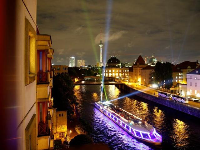 A boat with spotlights sails the Spree river during the opening day of the "Festival of Lights" show in Berlin, Germany. (REUTERS)