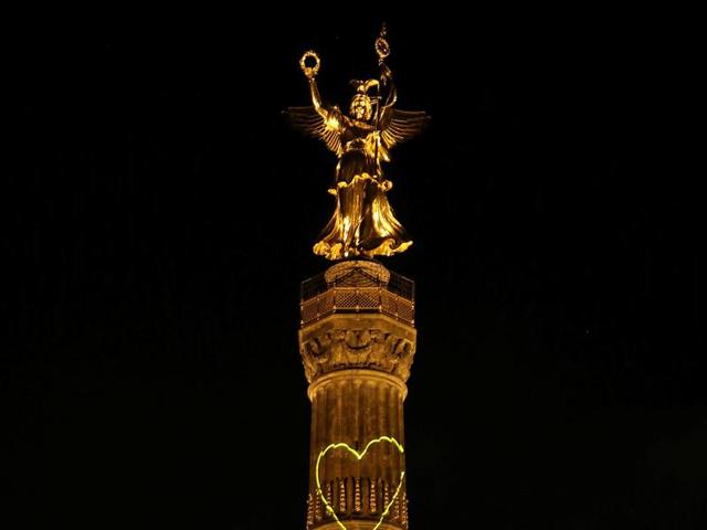 The Victory Column is illuminated during the Festival of Lights show in Berlin. (REUTERS)