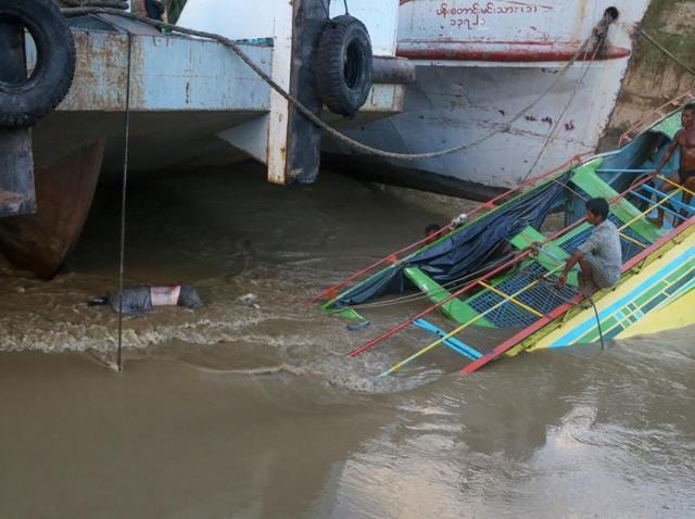 Rescue workers are seen on the sunken ferry partially lifted from the water near the river bank in central Myanmar. The death toll from the ferry disaster four days ago has risen to more than 50, officials said on Wednesday. (AFP) Rescue workers are seen on the sunken ferry partially lifted from the water near the river bank in central Myanmar. The death toll from the ferry disaster four days ago has risen to more than 50, officials said on Wednesday. (AFP)