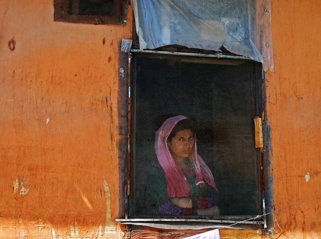 A woman looks out from a window during a protest in Kashmir, Srinagar.(Reuters File Photo) A woman looks out from a window during a protest in Kashmir, Srinagar.(Reuters File Photo)