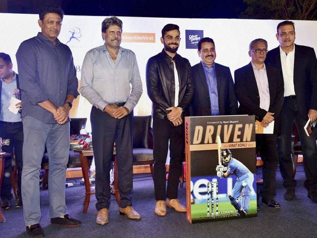 Indian test captain Virat Kohli shares a moment with former team mate, Virender Sehwag at the book launch of 'Driven: The Virat Kohli Story’, which traces his journey.(PTI)