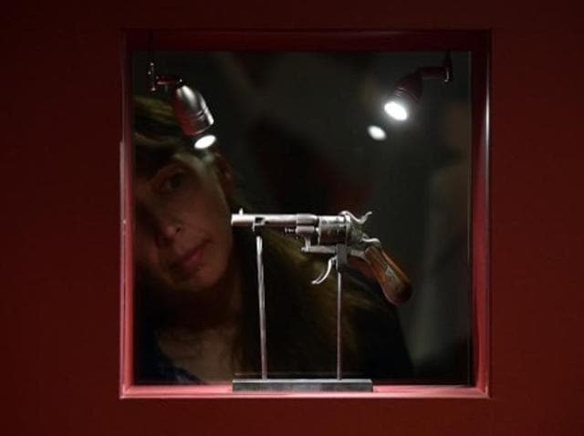 A visitor looks at the gun that French poet Paul Verlaine used to shoot fellow French poet Arthur Rimbaud, while visiting an exhibition on Verlaine. (AFP) A visitor looks at the gun that French poet Paul Verlaine used to shoot fellow French poet Arthur Rimbaud, while visiting an exhibition on Verlaine. (AFP)